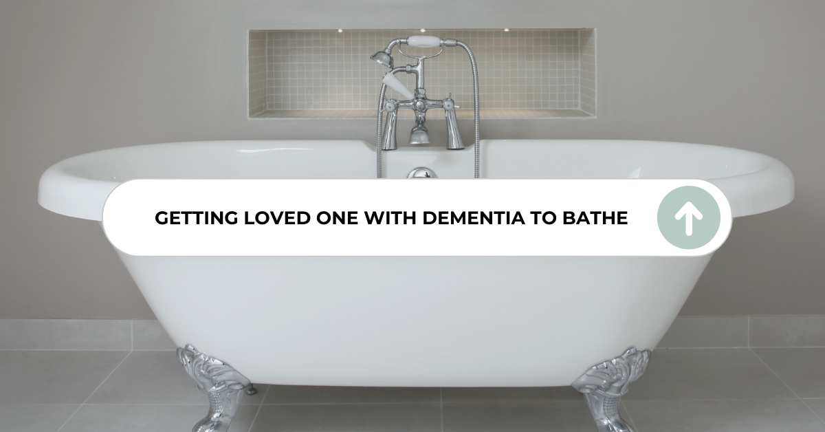 Vintage freestanding bathtub in a modern bathroom, with an overlay text stating 'Getting Loved One with Dementia to Bathe'