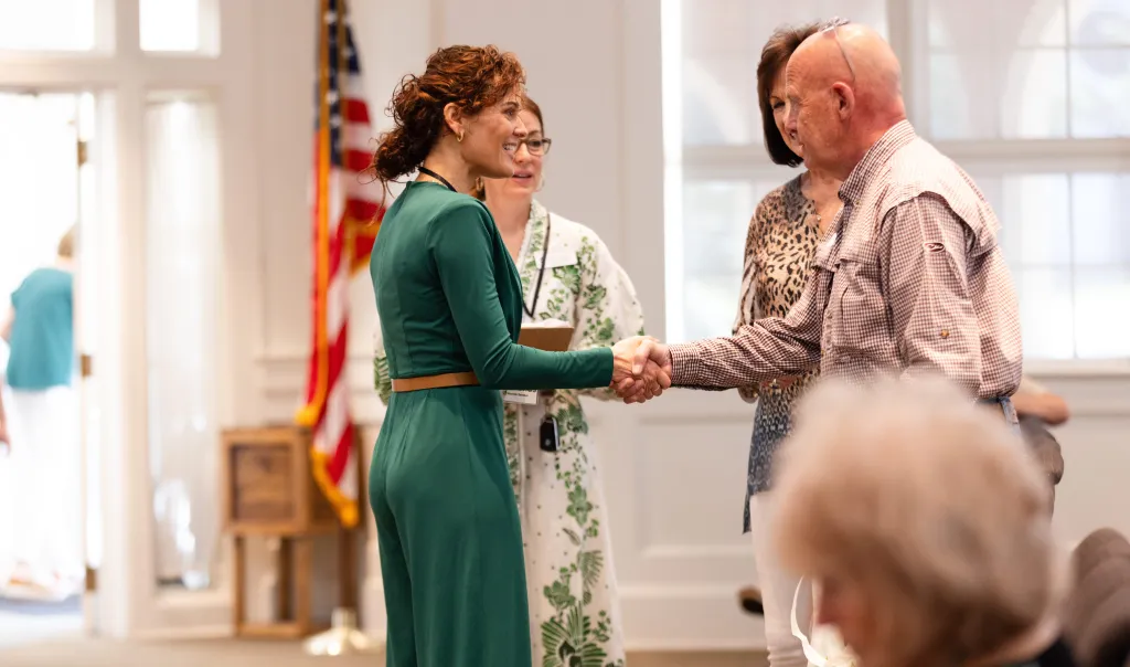 Dr. Natali Edmonds speaking with a Careblazer at an event for dementia caregivers.