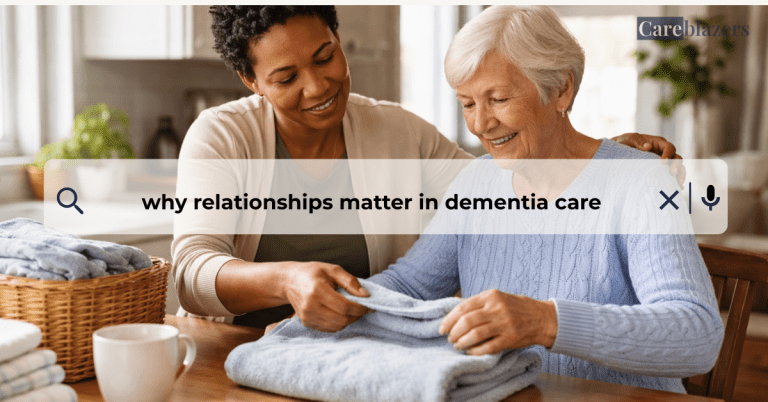 Caregiver and older adult with dementia folding laundry together at a kitchen table, sharing a calm and supportive moment of connection.