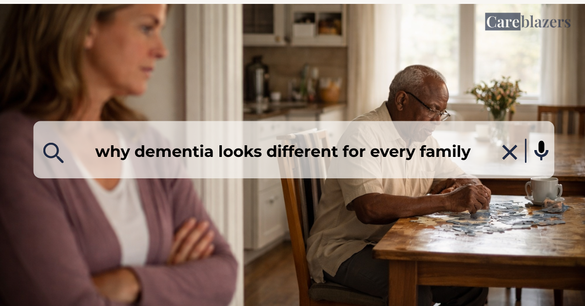 Older adult seated at a kitchen table working on a puzzle while a caregiver stands nearby in a calm home setting, showing quiet support and presence.