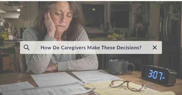 Exhausted dementia caregiver sitting alone at a kitchen table late at night struggling with difficult caregiving decisions